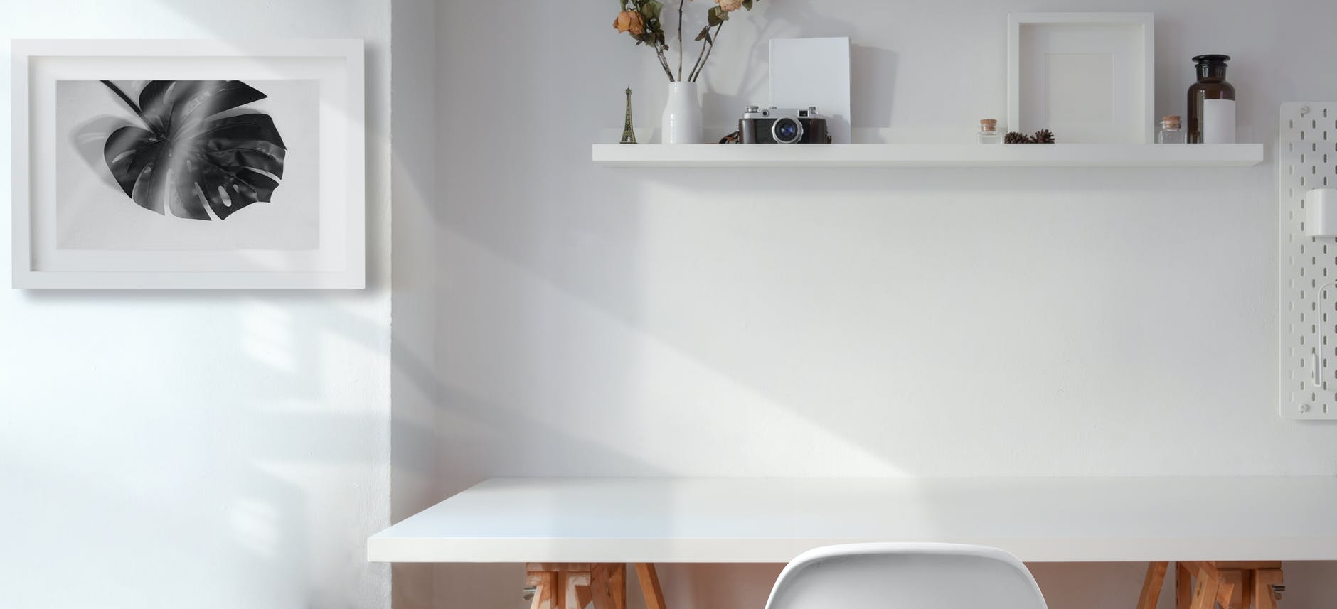 white wooden table near white wall