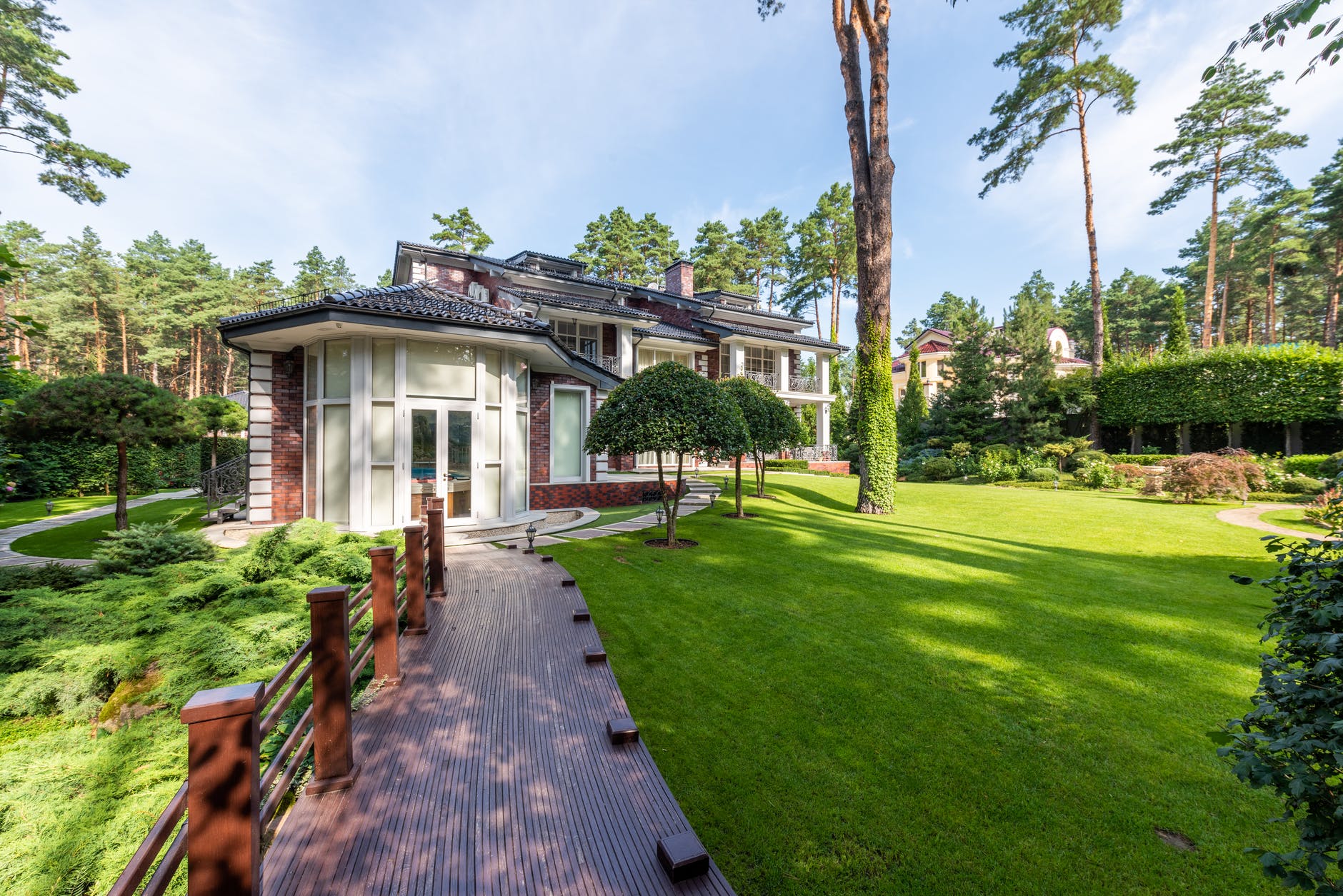 cottage exterior near plants with trees and pathway in yard